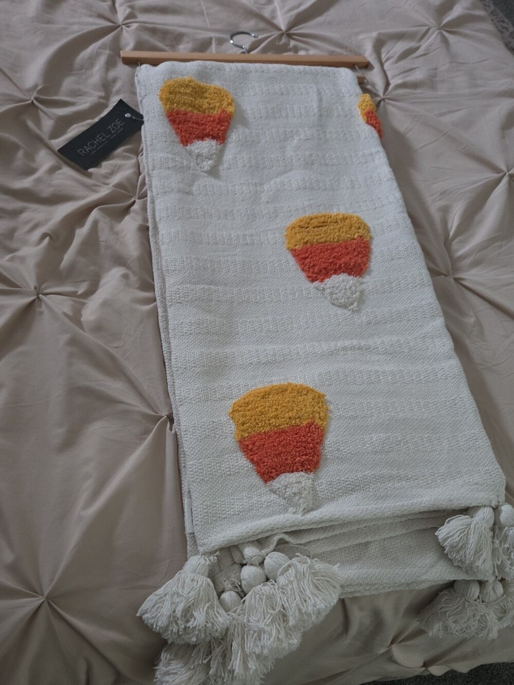 Rachel Zoe White Halloween Viral Throw with Orange and Yellow Tufted Accents.
